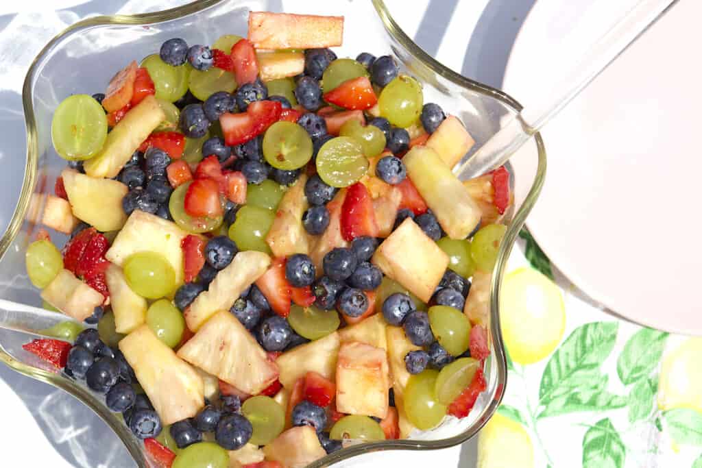 healthy side dish showing chopped fruit combination with honey lime dressing