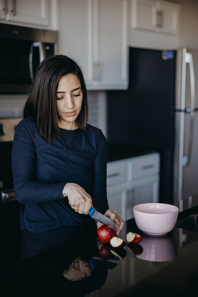 Weight loss dietitian cutting a red apple