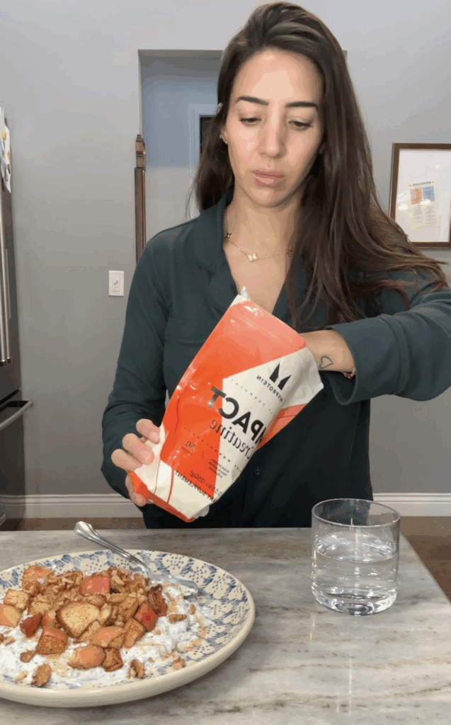 Creatine supplement powder and scoop on a countertop