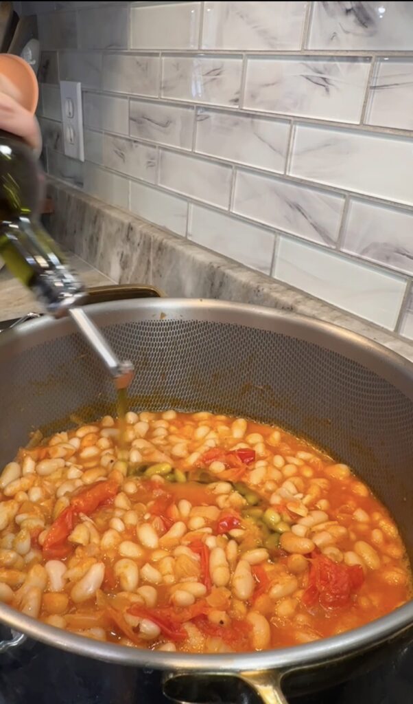Creamy white bean and tomato stew with olive oil drizzle