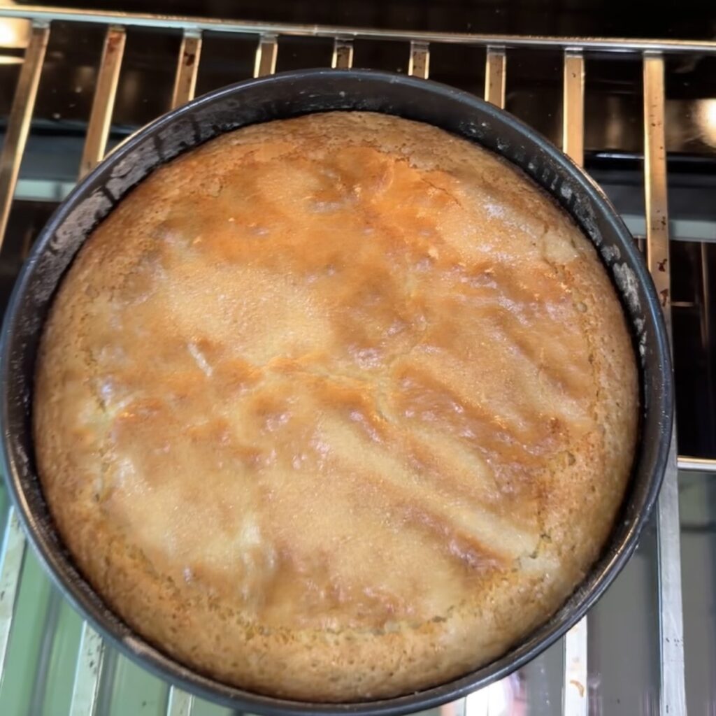 Freshly baked lemon olive oil cake in a round cake pan