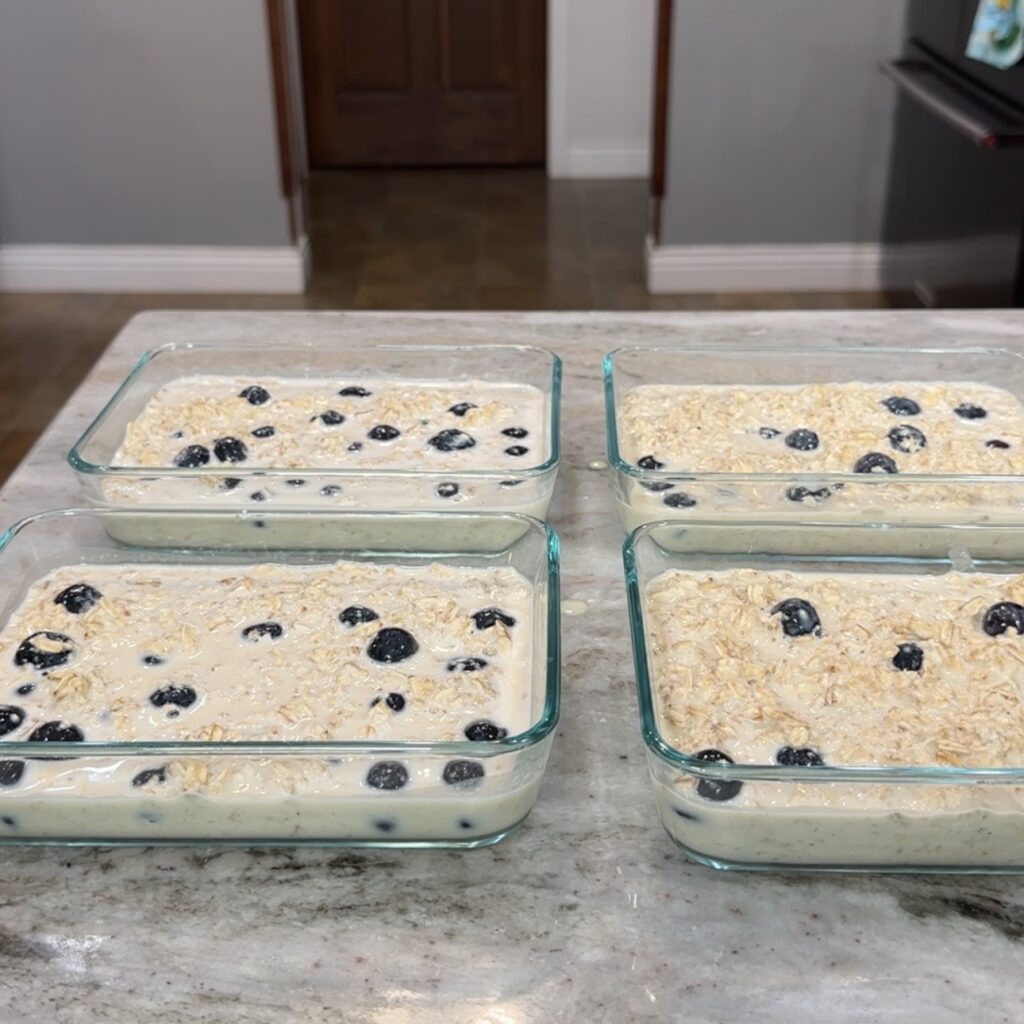 Glass meal prep containers filled with prepared meals and leftovers