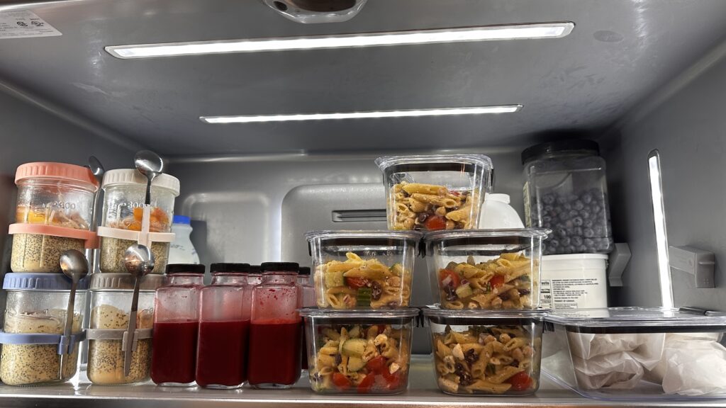 Organized refrigerator with meal prep containers for the week