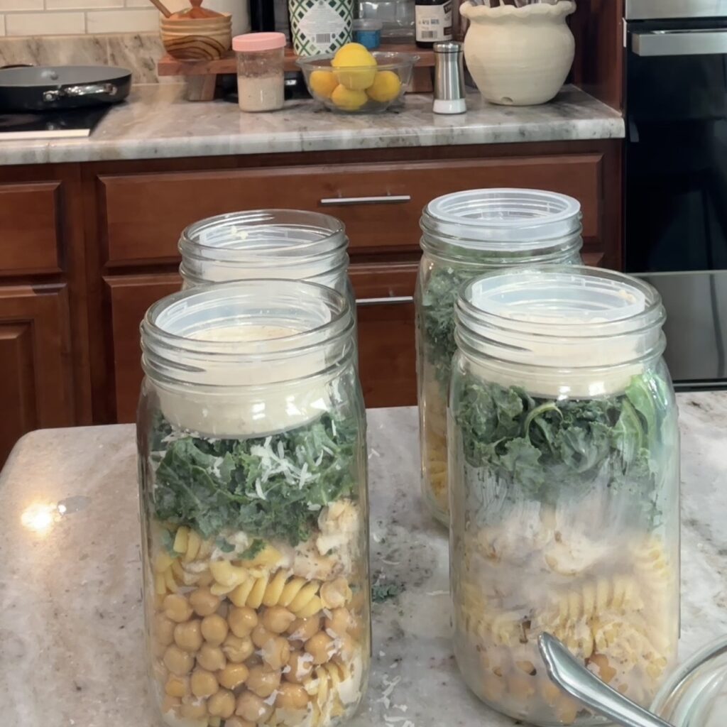 Mixing high-protein chicken Caesar pasta salad